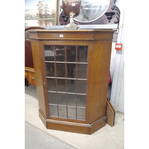 2142 - An Edwardian oak and glazed corner cabinet by Hamptons, Pall Mall, London