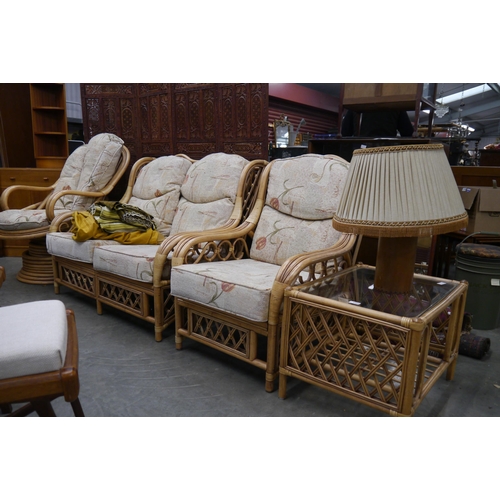 2452 - A modern bamboo three-piece conservatory suite comprising a two-seater sofa, a coffee table and an a... 