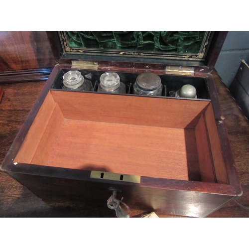 1070 - A rosewood vanity case with brass inlay, green velvet lining, pin boxes, perfume bottles etc. With k... 