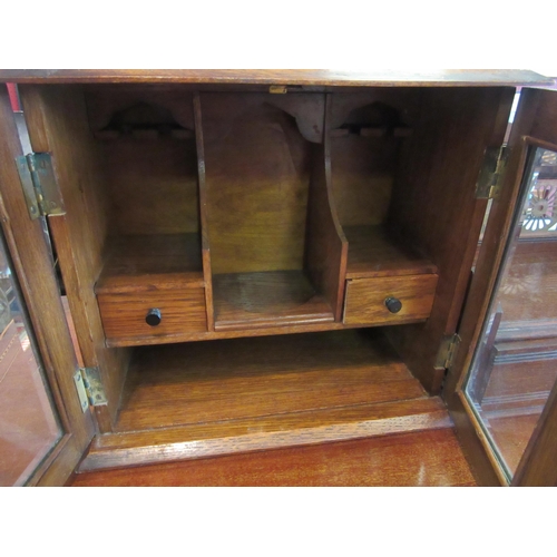 1100 - A vintage smoker's cabinet with glazed doors (with key) and a wooden smoker's pipe stand