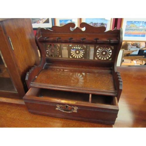 1100 - A vintage smoker's cabinet with glazed doors (with key) and a wooden smoker's pipe stand