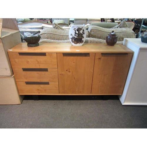 1141 - A modern light oak sideboard, three drawers and two doors, 76cm tall x 140cm wide x 39cm deep