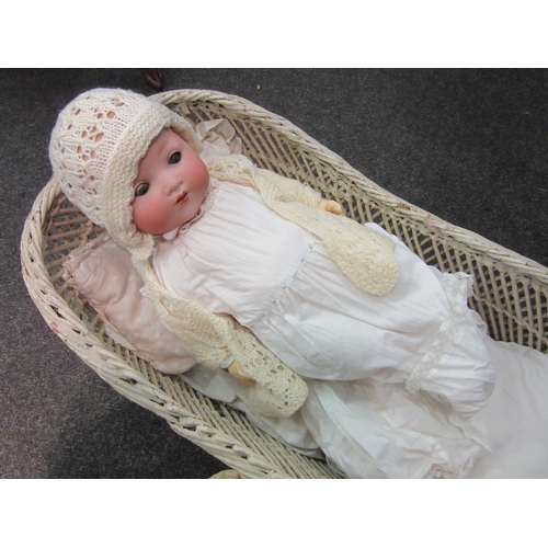 1189 - A German Armand Marseille doll in cradle