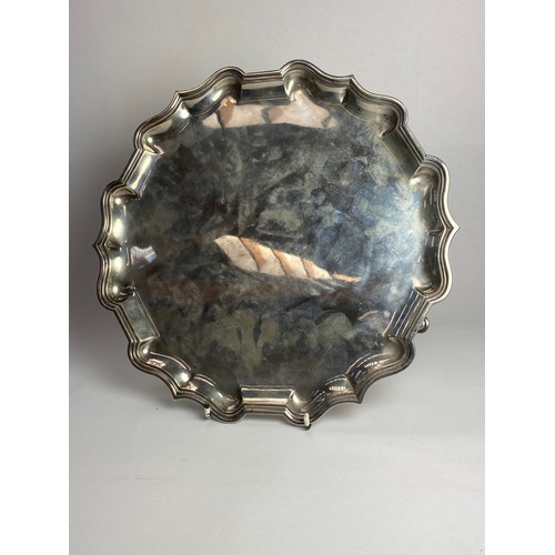 7007 - A large Charles Stuart Harris silver salver raised on three feet, London 1906, 31cm diameter, 936g