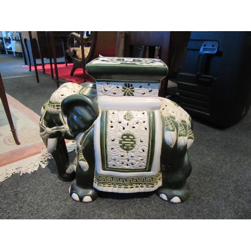 1061 - A Chinese ceramic elephant form jardiniere stand, 42cm tall