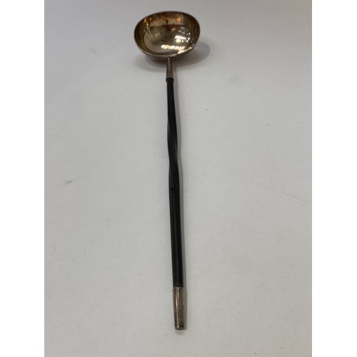 7101 - A Georgian toddy ladle unmarked with whale bone handle, 35cm long