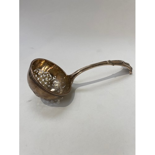 7109 - A George II Silver sifting ladle with scroll terminal London 1756, 17.5cm long, 104g