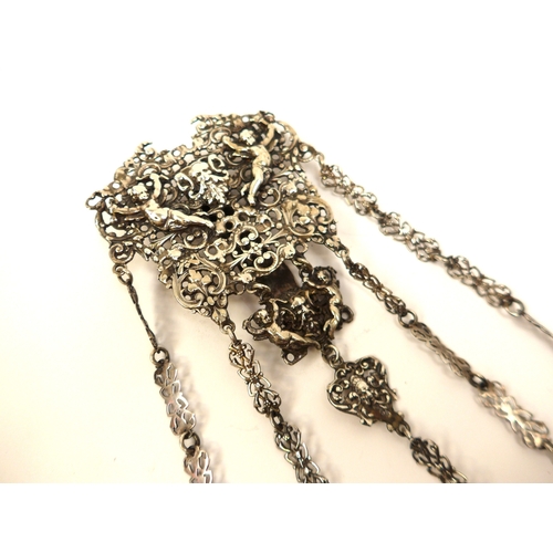 7114 - A Victorian silver five-chain chatelaine, pierced mask and cherubic design, London 1894. Thought to ... 