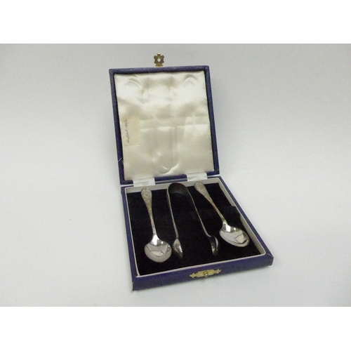 7129 - A silver sugar tong and teaspoon set with floral detail.  Cased.  Year date either 1966 or 1891.  50... 