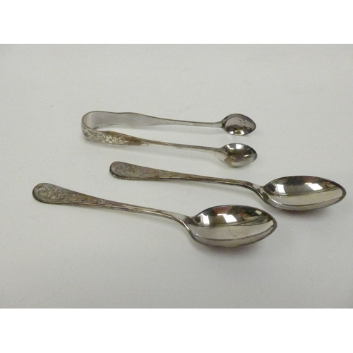 7129 - A silver sugar tong and teaspoon set with floral detail.  Cased.  Year date either 1966 or 1891.  50... 