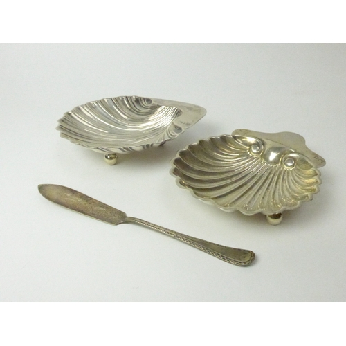 7130 - Two silver shell form butter dishes and knife including Dublin West & Son 1906 and London 1902, 178g