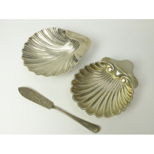 7130 - Two silver shell form butter dishes and knife including Dublin West & Son 1906 and London 1902, 178g