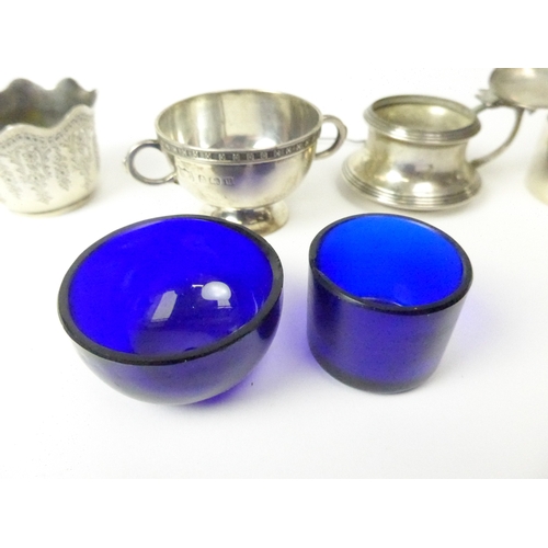 7137 - A silver mustard, salt, napkin ring and small bowl, various makers and dates (4), blue liners are ch... 