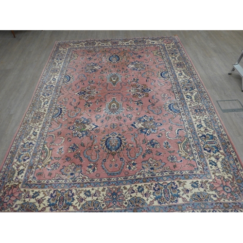 7631 - A pink ground carpet with substantial wear to one side, 247cm x 352cm