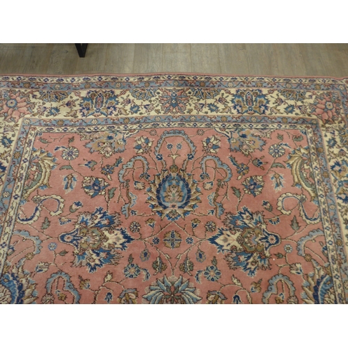 7631 - A pink ground carpet with substantial wear to one side, 247cm x 352cm