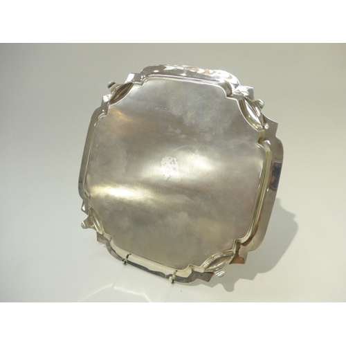 7006 - A Joseph Gloster Ltd. silver salver of shaped square form raised on four feet, Birmingham 1962, 30.5... 