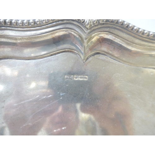 7010 - A Walker & Hall silver tray raised on three ball and claw feet with beaded edge Sheffield 1919, 37.5... 