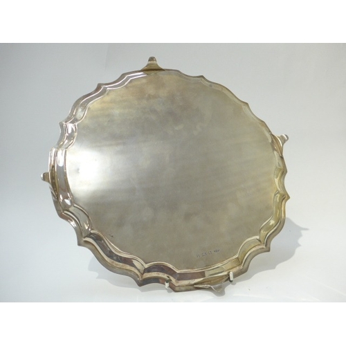 7001 - A Joseph Gloster Ltd silver tray with pie crust edge raised on four feet. Birmingham 1960. 35.5cm di... 