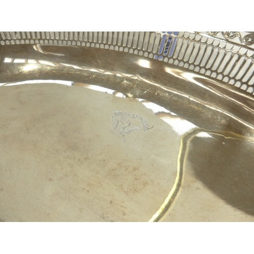 7003 - A Barrage Davenport George III silver pierced bread basket with beaded edge. Eel and heron crest wit... 