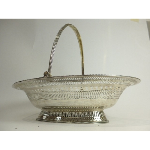 7003 - A Barrage Davenport George III silver pierced bread basket with beaded edge. Eel and heron crest wit... 