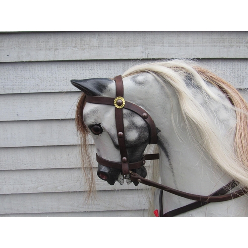 9201 - An early 20th Century crafted FH Ayres carved wood and painted gesso rocking horse, with fixed glass... 