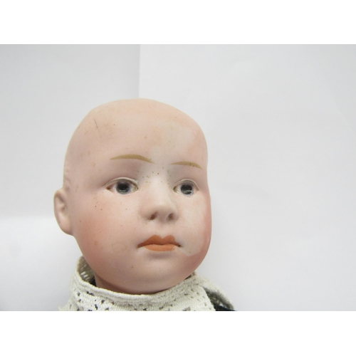 9321 - An early 20th Century Gebruder Heubach bisque head boy doll with Intaglio eyes, closed mouth, moulde... 