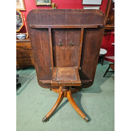 4080 - A circa 1860 flame mahogany tilt-top table on a turned column and outswept legs terminating on to or... 