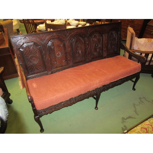 4215 - A 17th Century and later oak five panel back rest settle with carved decoration having a central her... 