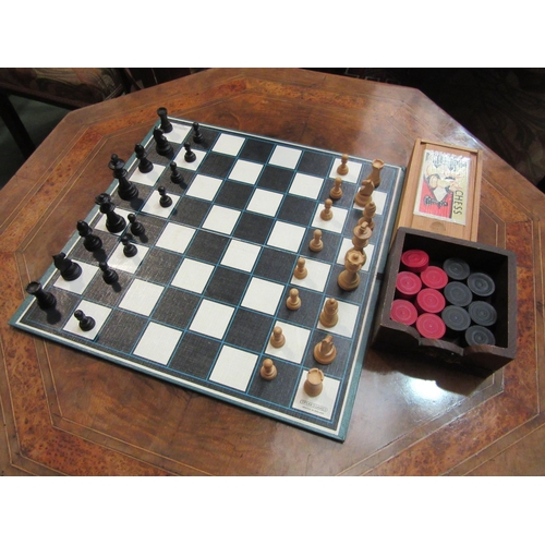 4234 - A wooden chess set and wooden draughts set with a Spear's Games board