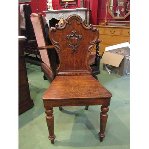 4236 - A mahogany carved shield back hall chair with turned fore legs