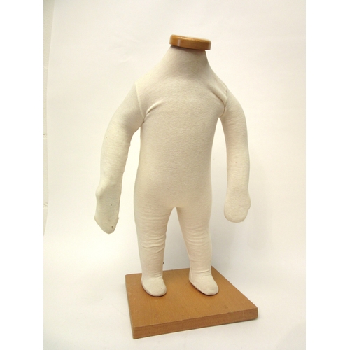 4245 - A modern child's padded mannequin on a square form wooden base