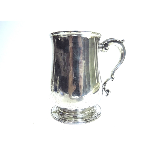 7085 - A George III James Waters baluster tankard with scroll handle, circular spread foot, dents present t... 