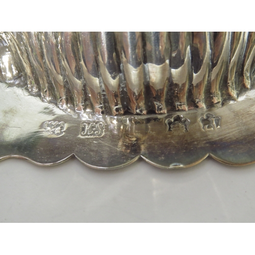 7058 - A pair of George II Samuel Herbert silver scallop-form butter dishes raised on conch shell feet, wit... 