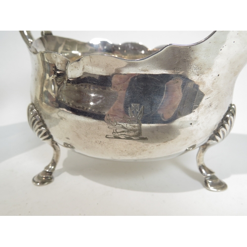 7084 - A pair of George III silver sauce boats, with S-scroll handle, hoof feet, boar's head crest, 8mm spl... 