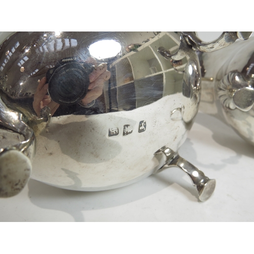 7084 - A pair of George III silver sauce boats, with S-scroll handle, hoof feet, boar's head crest, 8mm spl... 