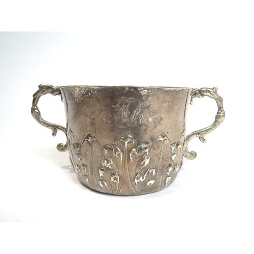 7066 - A Charles II silver porringer with Armorial crest and MB initialled monogram.  The base with maker's... 