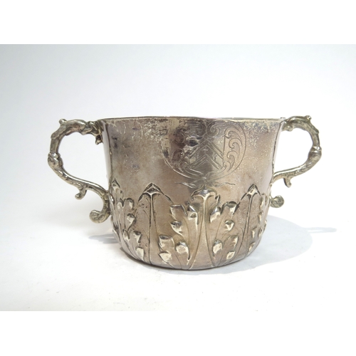 7066 - A Charles II silver porringer with Armorial crest and MB initialled monogram.  The base with maker's... 