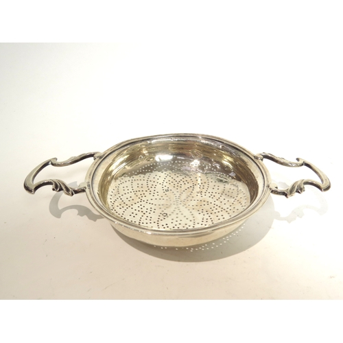 7054 - A George II silver lemon/orange strainer, marks rubbed but probably London 1752, 2.5cm tall x 11cm d... 