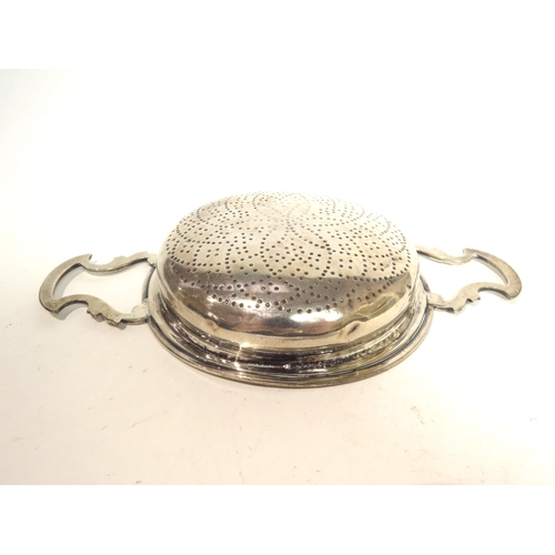 7054 - A George II silver lemon/orange strainer, marks rubbed but probably London 1752, 2.5cm tall x 11cm d... 