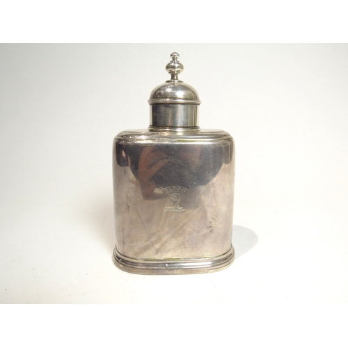 7083 - A George II silver tea caddy with removeable domed cap and a sliding base.  The body with dog's cres... 