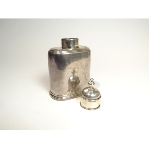 7083 - A George II silver tea caddy with removeable domed cap and a sliding base.  The body with dog's cres... 