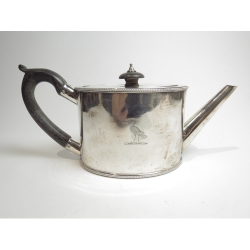 7078 - A George III silver oval-form teapot with beaded borders, bird crest detail to body, treen handle an... 