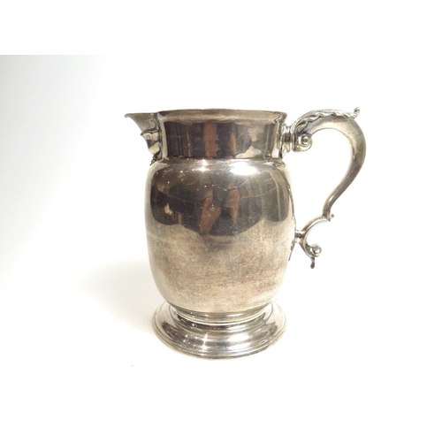 7070 - A George III William Grundy milk pitcher with acanthus leaf S-scroll handle with circular foot, Lond... 