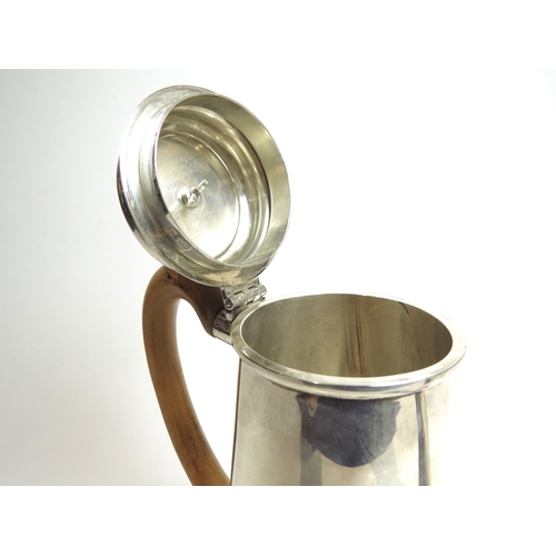 7071 - A Walter H. Willson Ltd silver coffee pot with treen finial and handle, London 1961, 22cm tall, 766g