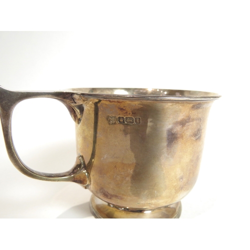 7081 - A Cooper Brothers & Sons Ltd silver mug, oversized handle, plain form, engraved with monogram over 1... 