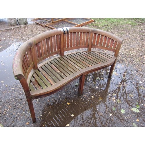 3444 - A curved teak garden bench