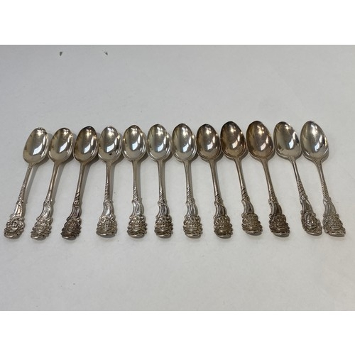 7099 - A quantity of Georgian fancy-back teaspoons grouped in an eight and four, all with similar bearded g... 