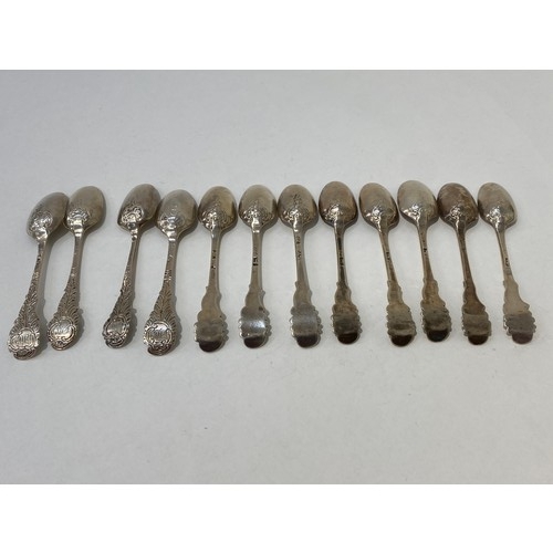 7099 - A quantity of Georgian fancy-back teaspoons grouped in an eight and four, all with similar bearded g... 