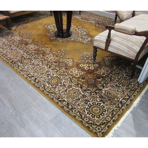 7632 - A mustard ground machine woven rug, central floral medallion, 266cm x 350cm