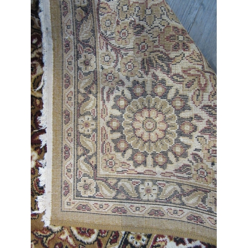 7632 - A mustard ground machine woven rug, central floral medallion, 266cm x 350cm